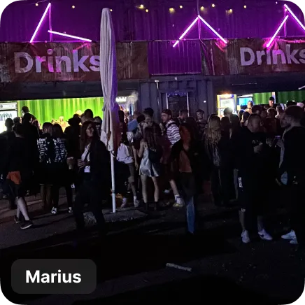 photo of a crowd in front of a bar