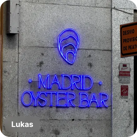 photo of a blue neon sign of a bar in madrid