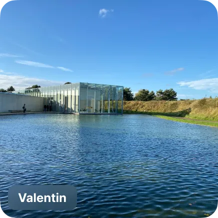 photo of a pond in front of a museum